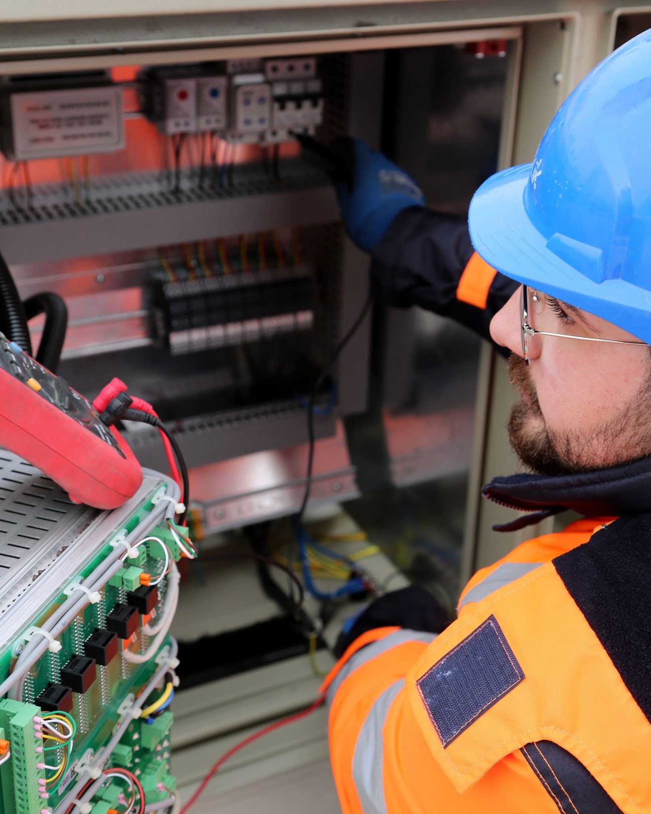 An electrician working on a distribution panel