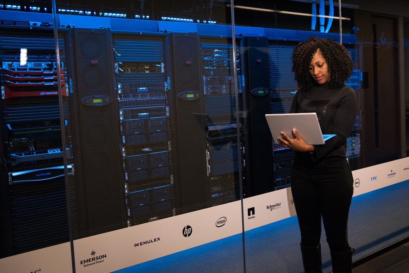 An engineer working beside server racks